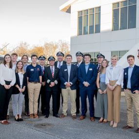 Auburn students and Southwest pilots stand in front of Auburn airplanes at the Destination 225 program celebration