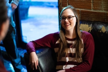 Girl sitting on a couch talking to someone
