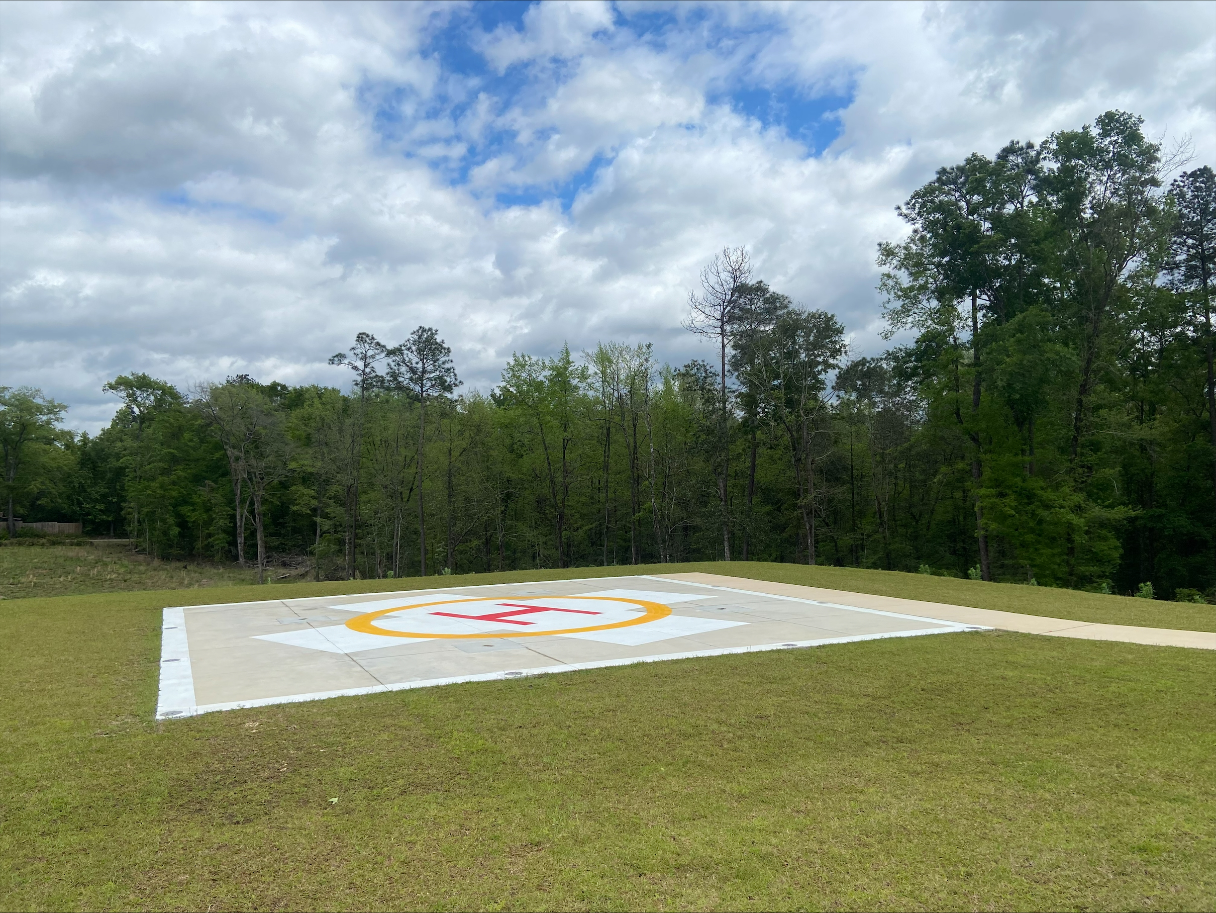 A helipad sits in a clearing