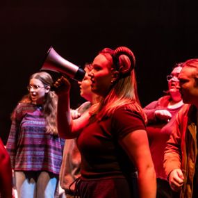 Student actor holding megaphone