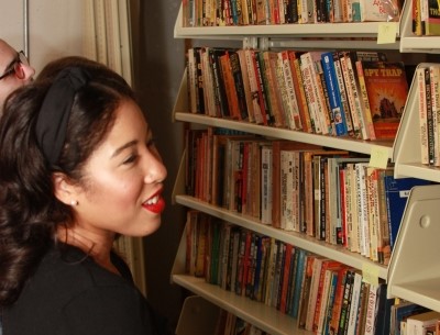 Student looking at books on a shelf