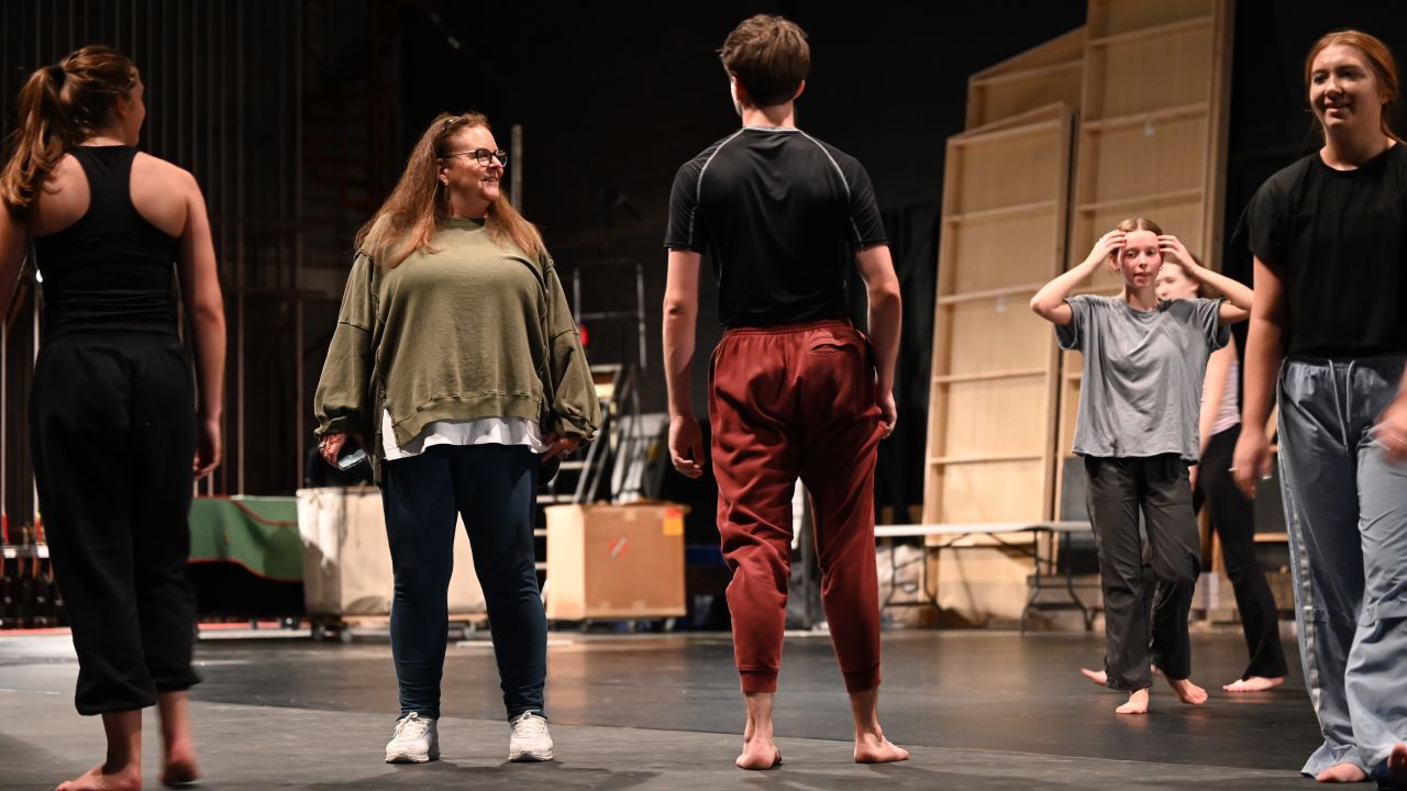 Adrienne Wilson instructing dancers on stage