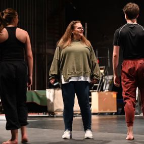 Adrienne Wilson instructing dancers on stage