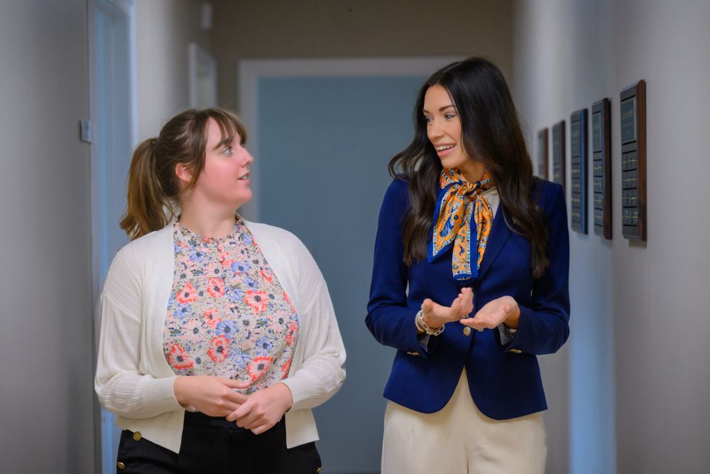 Katlyn Roland talking with a program coordinator in her office