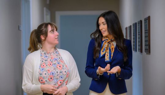 Katlyn Roland talking with a program coordinator in her office
