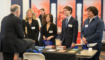Students speaking with a law school representative at Auburn's Law School Fair