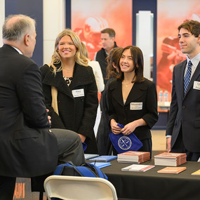 Students speaking with a law school representative at Auburn's Law School Fair