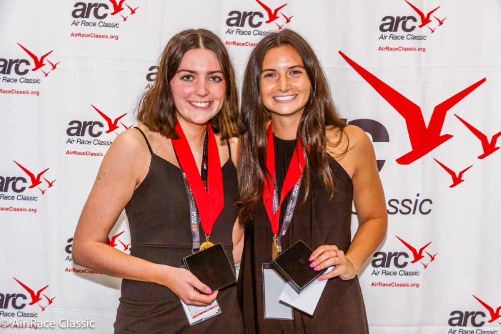 Abby Hagan and Ashley Baldwin hold up Air Race Classic awards