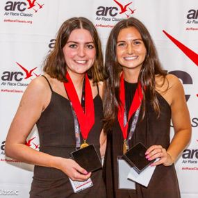 Abby Hagan and Ashley Baldwin hold up Air Race Classic awards