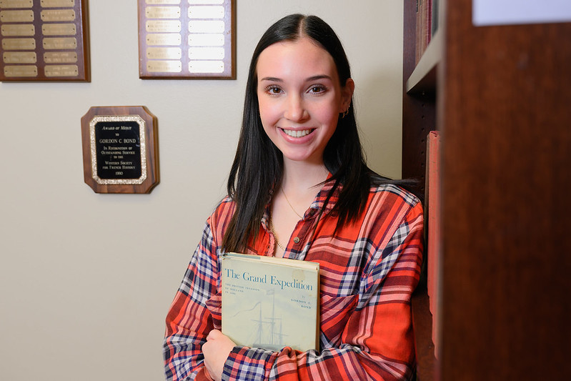Emma Bond holds a copy of The Grand Expedition, written by her grandfather, Gordon Bond