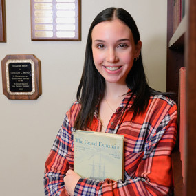 Emma Bond holds a copy of The Grand Expedition, written by her grandfather, Gordon Bond