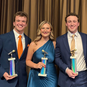 Students Vince Wolfram, Sydney Babb and Jack Corbett from Eagle Eye TV and advisor Billy Ferris holding Intercollegiate Broadcasting System Awards