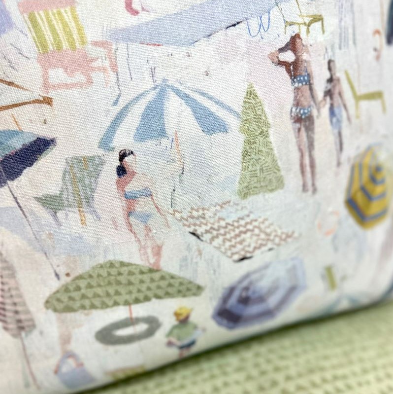 A painted beach scene printed onto a pillow