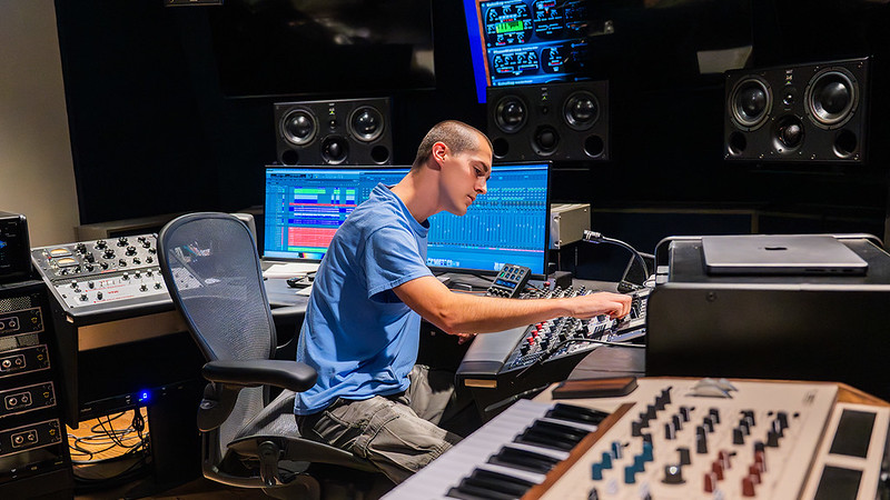 Student controlling sound equipment in the Lucky Man Studio