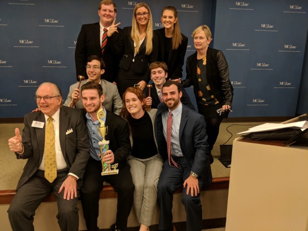 Group of students posing with a trophy