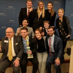 Group of students posing with a trophy
