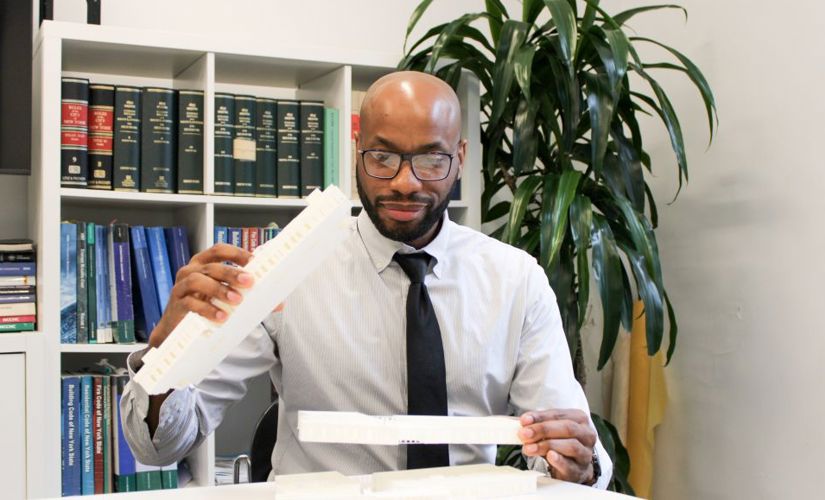 Bradley DeBose holding an architectural model