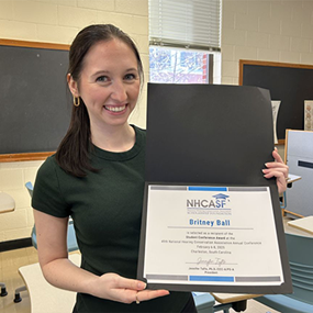 Britney Ball with her award certificate