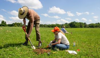 Students shovel testing land at Camp Watts