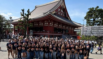 Large group of students standing in front of a building in Japan