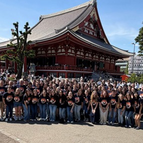 Large group of students standing in front of a building in Japan