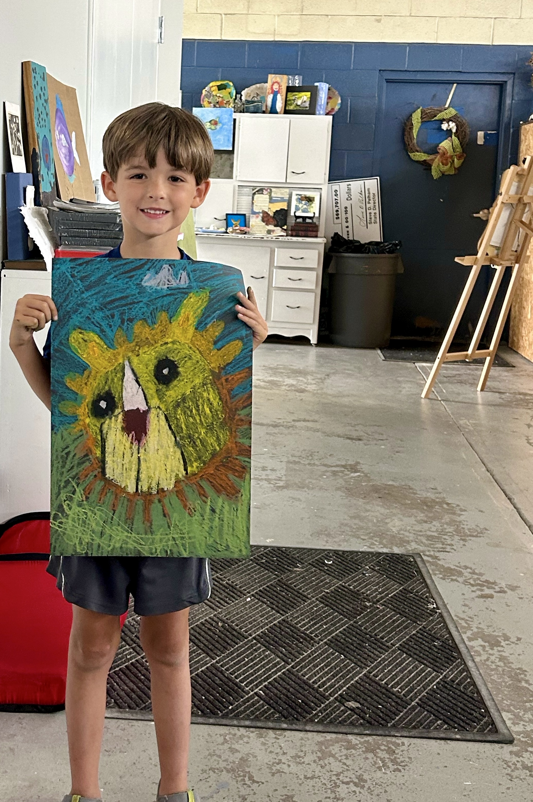 Liam Stallings practices the blending technique while using oil pastels.