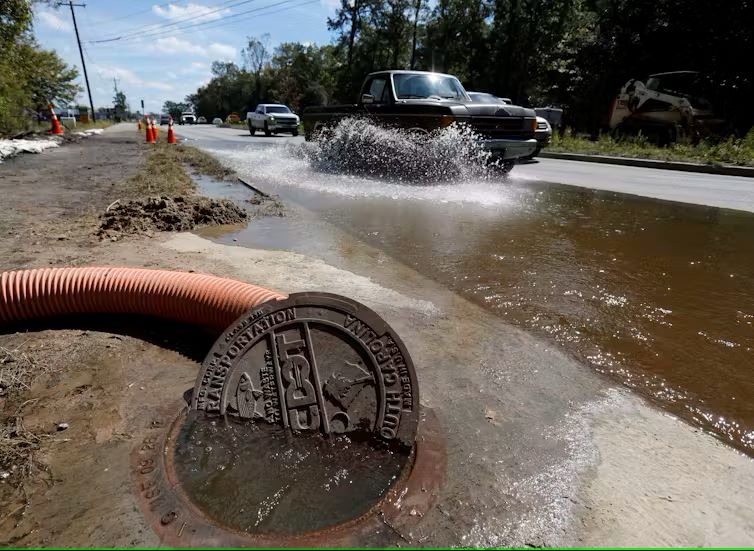 Water pouring out of manhole cover during flood
