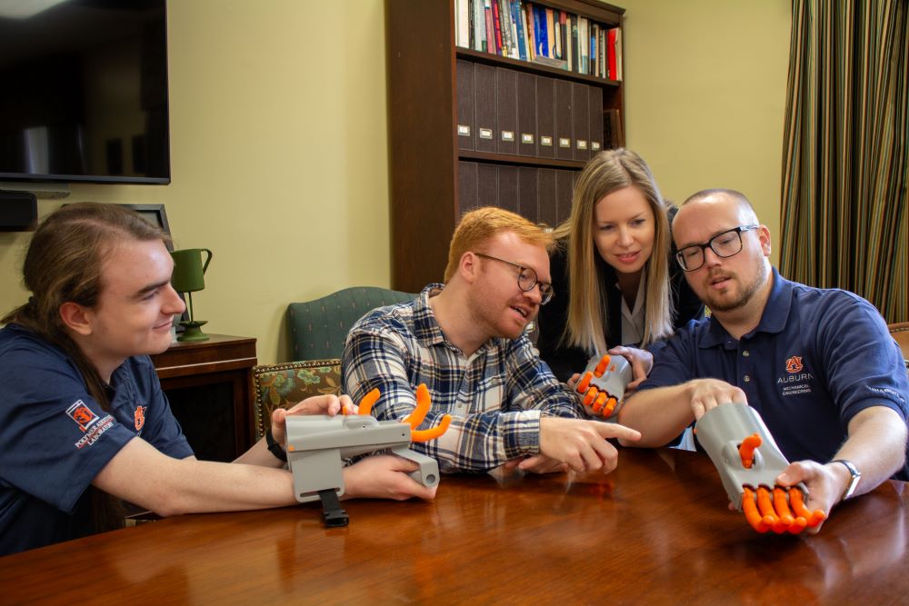 Faculty and students from History and Engineering examining a 3-D model of the Kassel Hand