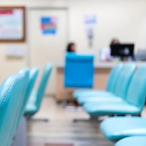 Rows of empty chairs sitting in a hospital waiting room