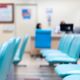 Rows of empty chairs sitting in a hospital waiting room