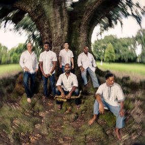 The New Creative Collective poses under a tree
