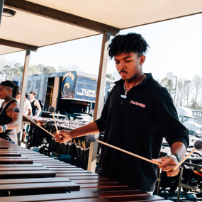 Student composer Josh Boyd playing an instrument