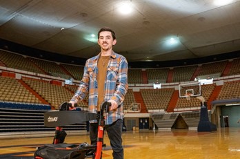 Noah Griffith stands on a basketball court