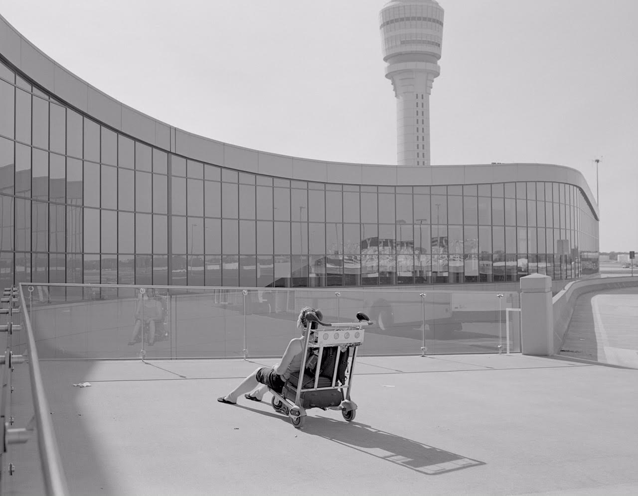 Mark Steinmetz, Untitled (woman in luggage cart, Atlanta Airport), silver gelatin print