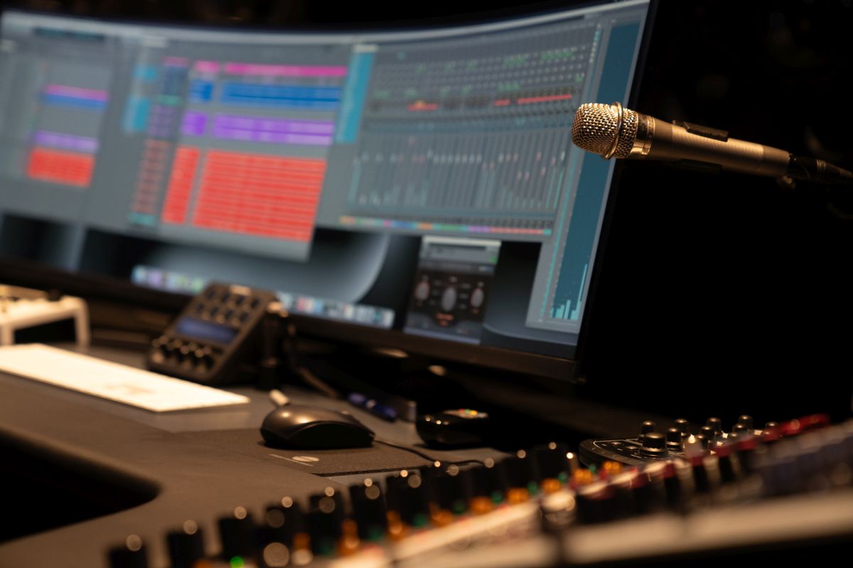 A recording studio featuring a computer monitor alongside a microphone for audio production