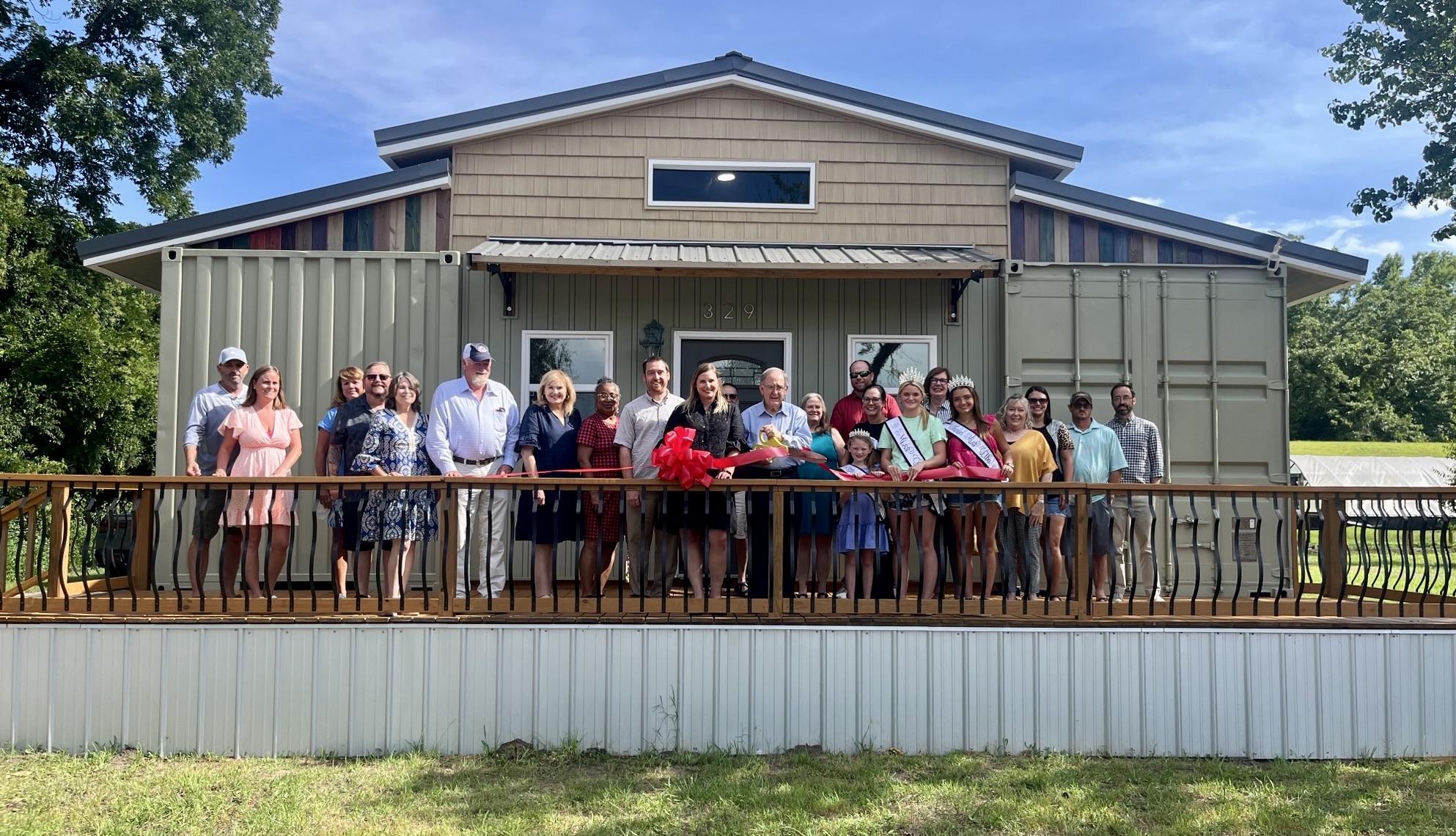 Attendees gather for the ribbon cutting and grand opening of Elba’s first Airbnb held July 8.