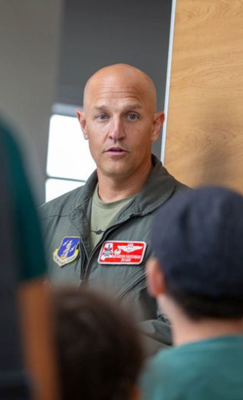 Flight instructor speaking to a group of kids