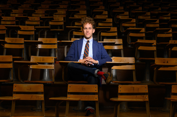 Elijah Gaddis sitting at a desk inside an Auburn University lecture hall