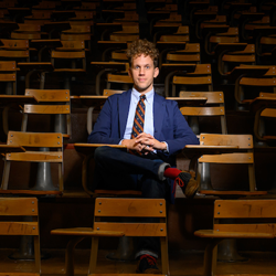 Elijah Gaddis sitting at a desk inside an Auburn University lecture hall