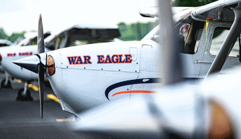 An Auburn-branded training aircraft sits on the runway, reflecting the real-world aviation context at the center of Physics for Aviators.
