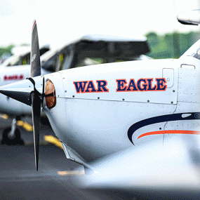 An Auburn-branded training aircraft sits on the runway, reflecting the real-world aviation context at the center of Physics for Aviators.