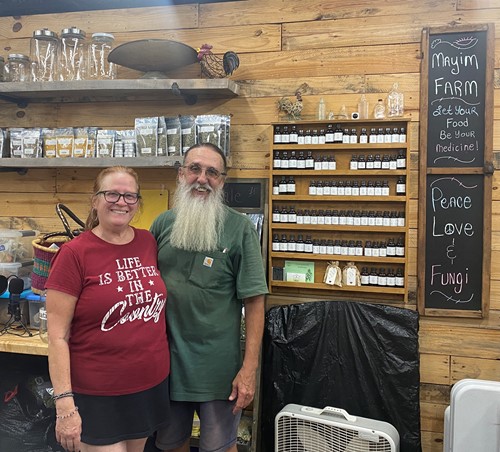 Carole and Greg Lolley stand in front of their medicinal plant products