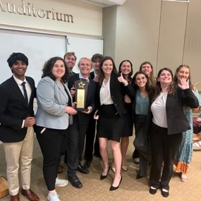 Group of students holding trophy