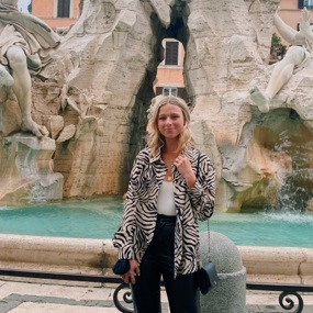 Emily Canniff standing in front of fountain