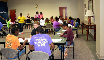 Youth sit at tables discussing community issues