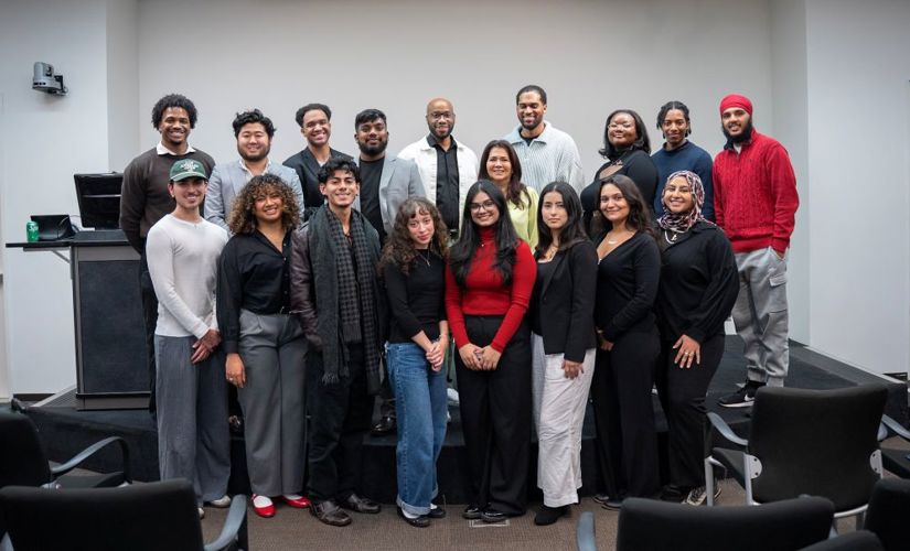 DeBose standing with a group of young professionals at an educational event