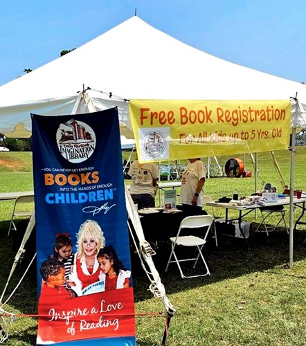 Dolly Parton's Imagination Library tent with free book registration advertised