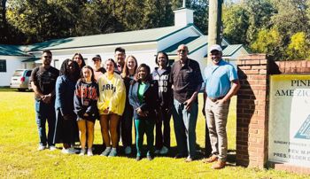 Group of students standing with Catherine Coleman Flowers 