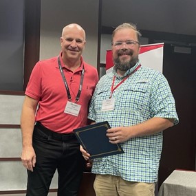 Phillip Coxwell receiving top research in progress award