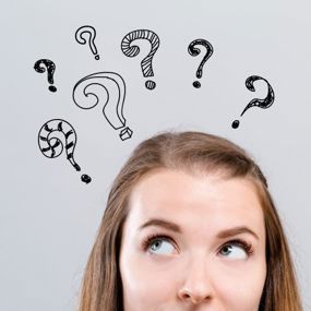 A woman thinking about something with question marks above her head